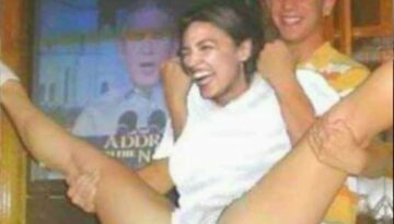 AOC legs spread at a party